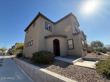 Charming two-story home featuring a tiled roof, landscaped front yard and an inviting arched entryway at 1745 W Pollack St, Phoenix, AZ 85041