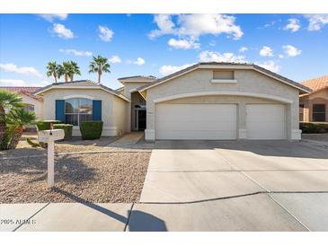 Charming home featuring a well-maintained yard and a spacious three-car garage at 17813 W Primrose Ln, Surprise, AZ 85374