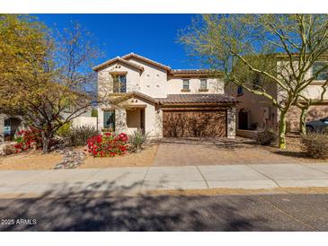 Charming two-story home with desert landscaping and a two-car garage, perfect for Gathering living at 2406 W Tallgrass Trl, Phoenix, AZ 85085