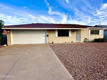 Charming single-story home with a two car garage, brick exterior and low maintenance landscaping at 3328 W Charter Oak Rd, Phoenix, AZ 85029