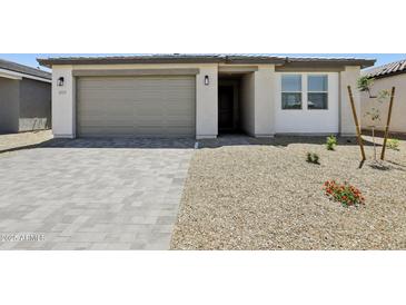 Charming single-story home featuring a neutral color palette, desert landscaping, and a spacious two-car garage at 4513 W 95Th Dr, Tolleson, AZ 85353