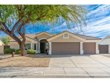 Charming single-story home features a three car garage, desert landscaping, and a mature shade tree at 4887 E Armor St, Cave Creek, AZ 85331