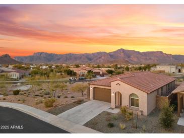 Charming home with a desert landscape, mountain views and an attached two car garage at 7165 S Bruins Rd, Gold Canyon, AZ 85118