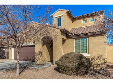 Charming two-story home featuring a tile roof, desert landscaping, and an arched entryway at 2324 W Melody Dr, Phoenix, AZ 85041