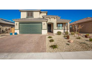 Beautiful two-story home with a well-manicured front yard and a two-car garage at 24578 W Concorda Dr, Buckeye, AZ 85326