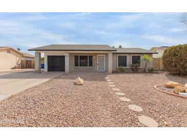 Charming single-story home with desert landscaping and a well-maintained front yard at 313 W Palomino Dr, Chandler, AZ 85225