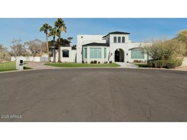 Stunning two story home with a circular drive and well manicured yard at 11745 N 99Th St, Scottsdale, AZ 85260