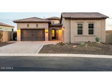 Inviting single-story home features a tile roof, desert landscaping, and a charming front entry at 12245 E Clinton St, Scottsdale, AZ 85259