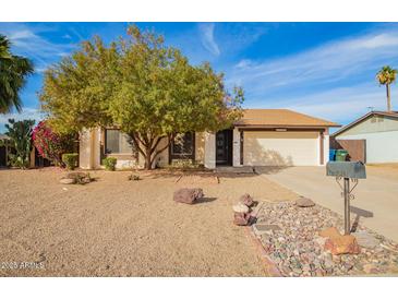 Charming single story home with mature shade tree and low maintenance desert landscaping at 17420 N 36Th Ave, Glendale, AZ 85308