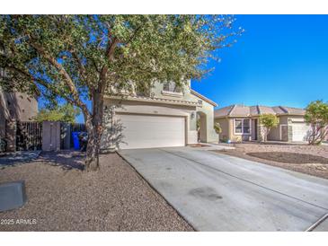 Charming two-story home featuring a low maintenance desert landscape and a large shade tree at 2325 S 88Th Dr, Tolleson, AZ 85353