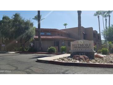 Biltmore Promenade Condominium sign with lush landscaping and mature trees at 2625 E Indian School Rd # 335, Phoenix, AZ 85016