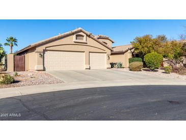 Charming home featuring a spacious three-car garage and well-manicured landscaping, creating an inviting curb appeal at 41762 W Little Ct, Maricopa, AZ 85138