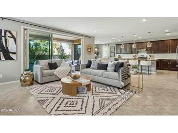 Open living room with neutral colors, stylish furnishings and a seamless flow to the outdoor living space at 8516 W Peppertree Ln, Glendale, AZ 85305