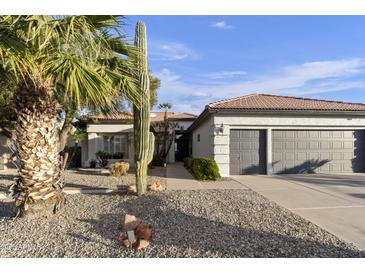 Charming home with stucco exterior, terra cotta roof, desert landscaping, and three car garage at 10232 E Lambert Dr, Sun Lakes, AZ 85248