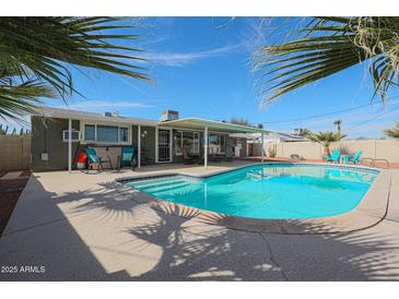 Beautiful backyard pool with sunny patio and view of the home under a bright, cloudless sky at 10722 W El Rancho Dr, Sun City, AZ 85351