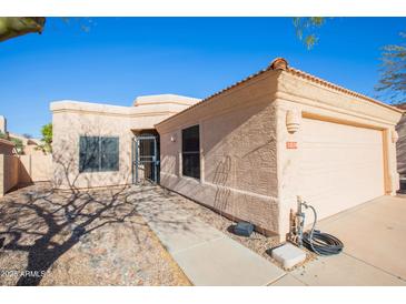 Single-story home featuring a two car garage, a low maintenance yard, and desert landscaping at 12224 N Gambel Dr, Fountain Hills, AZ 85268