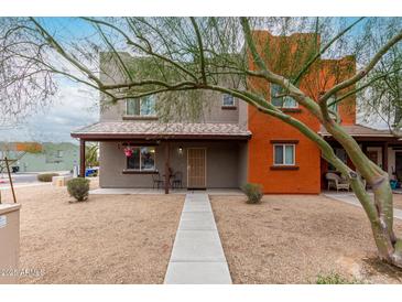 Inviting two-story home with a covered porch and low-maintenance landscaping for curb appeal at 16350 N Desert Sage St, Surprise, AZ 85378