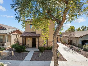 Charming two-story home with a covered front porch, landscaped yard, and extended driveway at 20821 W Ridge Rd, Buckeye, AZ 85396