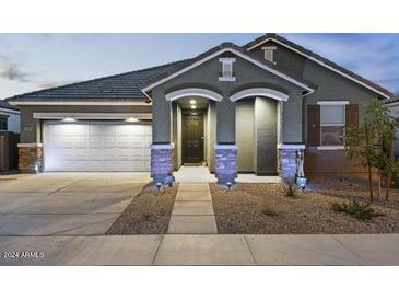 Charming single-story home with a two-car garage and well-manicured landscaping at 23282 S 229Th Pl, Queen Creek, AZ 85142