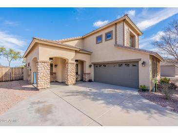 Charming two-story home featuring stone accents, neutral colors, and a spacious three-car garage at 2528 W Mericrest Way, San Tan Valley, AZ 85144