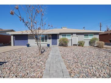 Charming single-story home featuring a well-maintained yard and a welcoming entrance at 8150 E Mitchell Dr, Scottsdale, AZ 85251