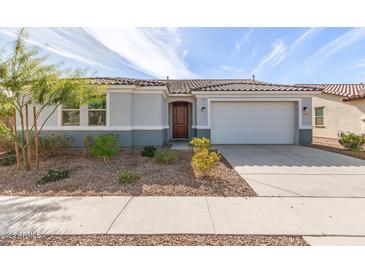 Charming single-story home with well-maintained landscaping and an attached two-car garage at 11441 W La Reata Ave, Avondale, AZ 85392