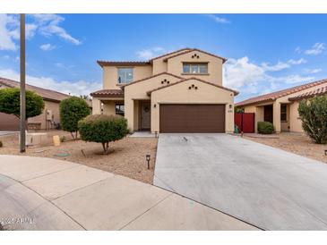 Charming two-story home featuring a desert landscape, brown garage door and a classic design at 16789 W Moreland St, Goodyear, AZ 85338