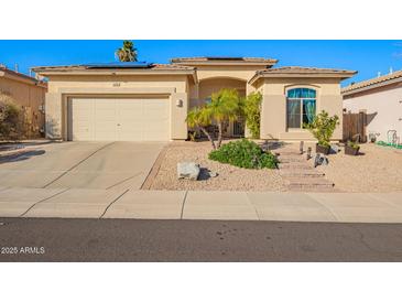 Charming single-story home featuring a desert landscape, solar panels, and a neutral-toned facade at 6442 W Cavedale Dr, Phoenix, AZ 85083