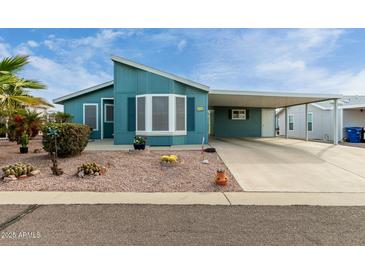 Charming single-Gathering home with a covered carport, xeriscaped yard, and freshly painted exterior at 8500 E Southern Ave # 488, Mesa, AZ 85209