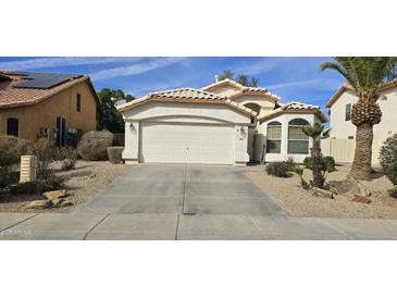 Charming single Gathering home features a two-car garage, desert landscaping, and a tile roof at 9614 W Mary Ann Dr, Peoria, AZ 85382