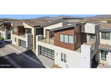 Modern townhome with multi-level balconies, sleek garage doors, and mountain views at 1 Easy St # 5, Carefree, AZ 85377