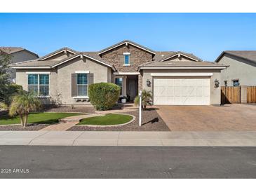 Charming single-story home features stone accents, a two-car garage, and well-maintained landscaping at 9388 W Cashman Dr, Peoria, AZ 85383