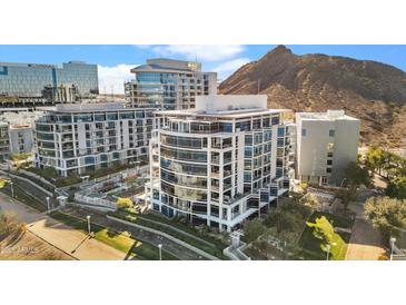 Modern condo building with curved balconies and floor-to-ceiling windows overlooking green space and a mountain backdrop at 120 E Rio Salado Pkwy # 602, Tempe, AZ 85281