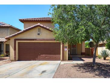 Charming two-story home featuring a brown garage door, desert landscaping, and a welcoming front entrance at 12054 W Aster W Dr, El Mirage, AZ 85335