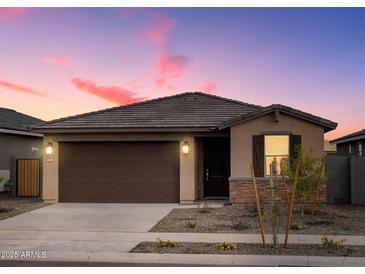 Charming single-story home features a well-kept front yard, neutral color palette, and a two-car garage at 16020 W Hackamore Dr, Surprise, AZ 85387