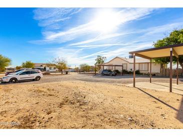 Wide open property with long driveway and covered parking at 19412 W Clarendon Ave, Litchfield Park, AZ 85340