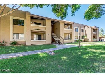 Attractive two-story condo building with well-maintained landscaping and walkways at 2146 W Isabella Ave # 215, Mesa, AZ 85202