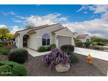 Attractive desert home with a well-manicured front yard and two-car garage at 26787 W Mohawk Ln, Buckeye, AZ 85396