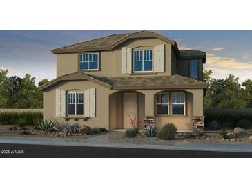 Two-story home featuring stone veneer accents, shuttered windows, and a covered front entryway at 3767 N 99Th Dr, Avondale, AZ 85392