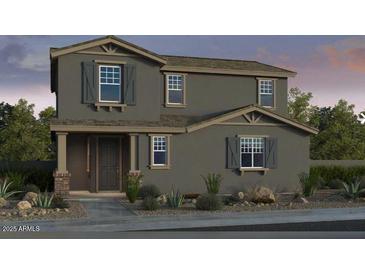 Two-story home featuring a neutral color scheme, complemented by decorative shutters, and a well-maintained front yard at 3809 N 99Th Dr, Avondale, AZ 85392