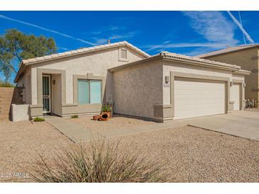 Charming single-story home with a well-maintained front yard and two car garage at 502 E Mountain View Rd, San Tan Valley, AZ 85143