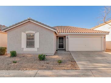 Charming single-story home featuring a well-maintained yard and a spacious two-car garage at 665 E Winchester Way, Chandler, AZ 85286