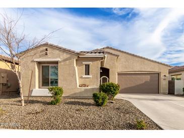 Charming single-story home with desert landscaping and attached two-car garage at 7533 S Woodchute Dr, Gold Canyon, AZ 85118