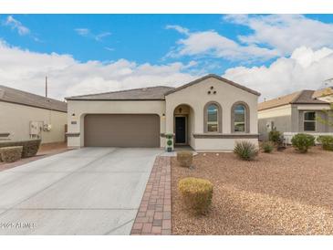 Charming single-story home featuring a two-car garage and attractive desert landscaping at 3530 N 310Th Dr, Buckeye, AZ 85396