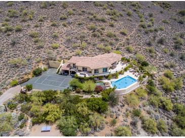 Expansive property featuring a large pool, tennis court, and lush landscaping on a hillside at 36879 N 38Th St, Cave Creek, AZ 85331