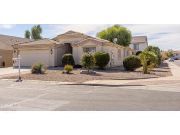 Beige single-story home featuring desert landscaping and a tile roof at 43639 W Blazen Trl, Maricopa, AZ 85138