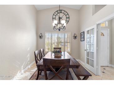 Bright dining room boasts a decorative clock and a rustic wooden table set for a comfortable dining experience at 4502 E Hartford Ave, Phoenix, AZ 85032