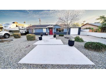 Charming blue single-story home with desert landscaping, gravel, and a welcoming red front door at 1207 E Alice Ave, Phoenix, AZ 85020