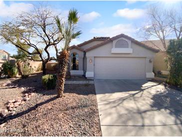 Charming single-story home with a desert landscaped front yard and an attached two-car garage at 829 E Compass Ct, San Tan Valley, AZ 85143