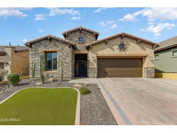 Charming stone-accented home with a well-manicured lawn and inviting desert landscape at 2066 N Canelo Hls, Mesa, AZ 85207